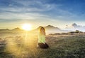 Beautiful european woman sitting on the grass during sunset time in mountains Royalty Free Stock Photo