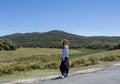 Beautiful european woman standing on the road at the Horton`s Plains national park