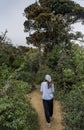 Beautiful european woman walking on the way to the tropical forest