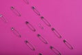 Beautiful even rows of silver safety pins in various sizes and shapes. Royalty Free Stock Photo