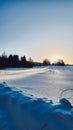 Beautiful evening landscape. Fantastic winter sunset. Field of white snow and ice on horizon. Light and airy feel and Royalty Free Stock Photo