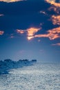 A beautiful evening landscape of a frozen breakwater in the Baltic sea. Winter landscape at the beach.