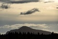 Beautiful evening light with dramatic cloudy sky, tree line in silhouette, mountain profile, Katmai National Park, Alaska, USA