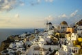 Beautiful evening light scene of Oia white building townscape and windmill along island mountain, vast Aegean sea, soft cloud Royalty Free Stock Photo