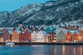 Beautiful evening panorama of Bergen waterfront, Bryggen area. Magical cityscape at night, visible colorful houses of Bergen. Long Royalty Free Stock Photo