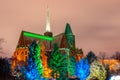 Beautiful evening park with a church with illuminated trees wroclaw