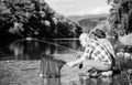 Beautiful evening riverside. Men riverside catching fish. Teaching fishing. Sharing his secrets. Transferring knowledge Royalty Free Stock Photo