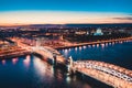 Beautiful evening scene with the famous Tower Bridge of St.Petersburg illuminated and reflected in Neva river