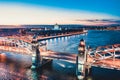 Beautiful evening scene with the famous Tower Bridge of St.Petersburg illuminated and reflected in Neva river