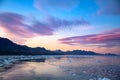 Evening sky with foehn clouds - Lenticularis clouds - over mountains reflecting in ocean with ice floes, South Georgia Royalty Free Stock Photo