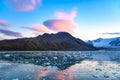 Evening sky with foehn clouds - Lenticularis clouds - over mountains reflecting in ocean with ice floes, South Georgia Royalty Free Stock Photo