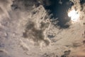 Beautiful evening skyscape. Sun`s rays shine through hole in black clouds after rain, natural background Royalty Free Stock Photo