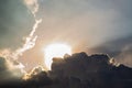 Beautiful evening skyscape. Sun`s rays shine through hole in black clouds before rain, natural background Royalty Free Stock Photo