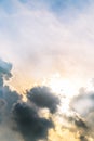 Beautiful evening skyscape. Sun`s rays shine through hole in black clouds after rain