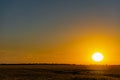 Beautiful evening sunset over a field of Golden ears of wheat and barley. Yellow is the rich color of the Sunny sky Royalty Free Stock Photo