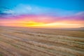 Beautiful evening sunset over the mown wheat field Royalty Free Stock Photo