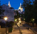 Beautiful evening view of Montmartre street and the Sacre-Coeur in Paris, France . Royalty Free Stock Photo