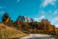 Road going toward high mountain as a symbol of challenge in dolomites epic landscape in sunny day