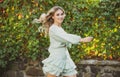 Beautiful excited smiling woman in fashionable spring clothes outdoors. Female stylish model walking city street. Spring Royalty Free Stock Photo