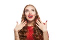 Beautiful excited woman with red manicured nails on white background