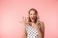 Beautiful excited young blonde woman wearing dress