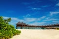 Beautiful exotic beach and amazing wooden bungalow on turquoise water Royalty Free Stock Photo