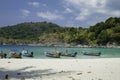 Beautiful exotic boats in lagoon. Seascape with transparent azure water and coast with tropical forest. Royalty Free Stock Photo