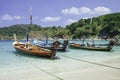 Beautiful exotic boats in lagoon. Seascape with transparent azure water and coast with tropical forest. Royalty Free Stock Photo