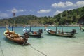 Beautiful exotic boats in lagoon. Seascape with transparent azure water and coast with tropical forest. Royalty Free Stock Photo