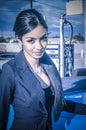 Beautiful exotic young woman pumping gas Royalty Free Stock Photo