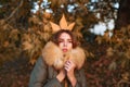 Beautiful exquisite girl standing in the park freezing in a jacket with fur. Autumn queen. Fall season outfit. Modern Royalty Free Stock Photo