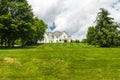 Beautiful exterior of a luxury home on a hill. Yard with green grass and trees Royalty Free Stock Photo