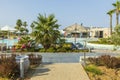 Beautiful exterior of modern resort hotel with an outdoor pool against blue sky. Royalty Free Stock Photo