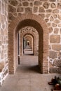 Beautiful external hallway with stones and supported by columns and arches in Toledo Spain