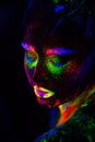 Beautiful extraterrestrial model woman in neon light. It is portrait of beautiful model with fluorescent make-up, Art Royalty Free Stock Photo