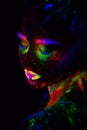 Beautiful extraterrestrial model woman in neon light. It is portrait of beautiful model with fluorescent make-up, Art Royalty Free Stock Photo