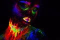 Beautiful extraterrestrial model woman in neon light. It is portrait of beautiful model with fluorescent make-up, Art Royalty Free Stock Photo