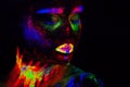 Beautiful extraterrestrial model woman in neon light. It is portrait of beautiful model with fluorescent make-up, Art Royalty Free Stock Photo