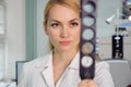 Beautiful eye doctor woman with ophthalmologic device in the cabinet Royalty Free Stock Photo