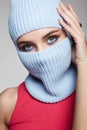 Beautiful eyes of girl in blue balaclava. New Hat style Royalty Free Stock Photo