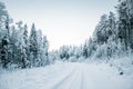 Beautiful fabulous winter landscape, the road going through the forest, everything is covered with snow Royalty Free Stock Photo