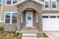 Beautiful facade of home with arched stone entrance and glass paned front door Royalty Free Stock Photo