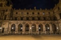 Beautiful facade of the Louvre Palace in Paris at night Royalty Free Stock Photo