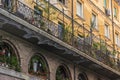 beautiful facade of an old building on a street in Rome, decorated with flowers Royalty Free Stock Photo