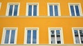 Beautiful yellow facade, restored building exterior in old town. Royalty Free Stock Photo