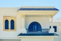 Beautiful facade of white Arab house with blue windows in Tunisia Royalty Free Stock Photo