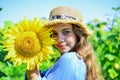Beautiful face little girl playing sunflowers nature background