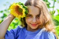 Beautiful face little girl playing sunflowers nature background, beauty concept