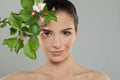 Beautiful face. Perfect young woman closeup portrait. Female model with spring apple flowers Royalty Free Stock Photo