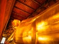 Beautiful face of Reclining Buddha, and thai art architecture in Wat Phra Chetupon Vimolmangklararm Wat Pho temple They are